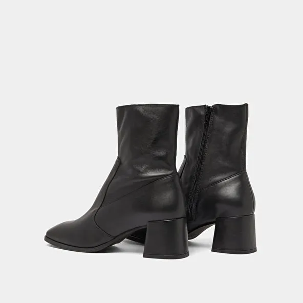 Oval-toe boots in black aged leather